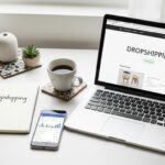 Top view of a workspace setup for launching a dropshipping business with minimal investment